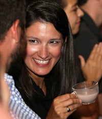 a woman holding a cup of coffee