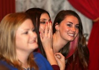 a group of women are laughing at a party